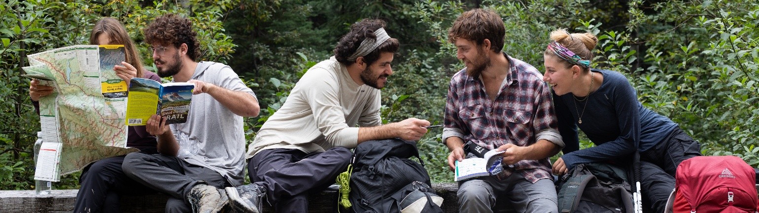 hikers discuss their plans while out on the trail