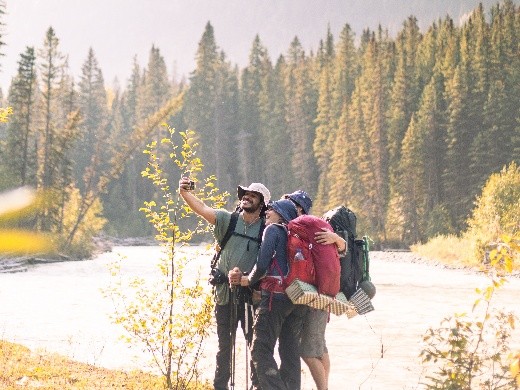 hikers taking a selfie along a river