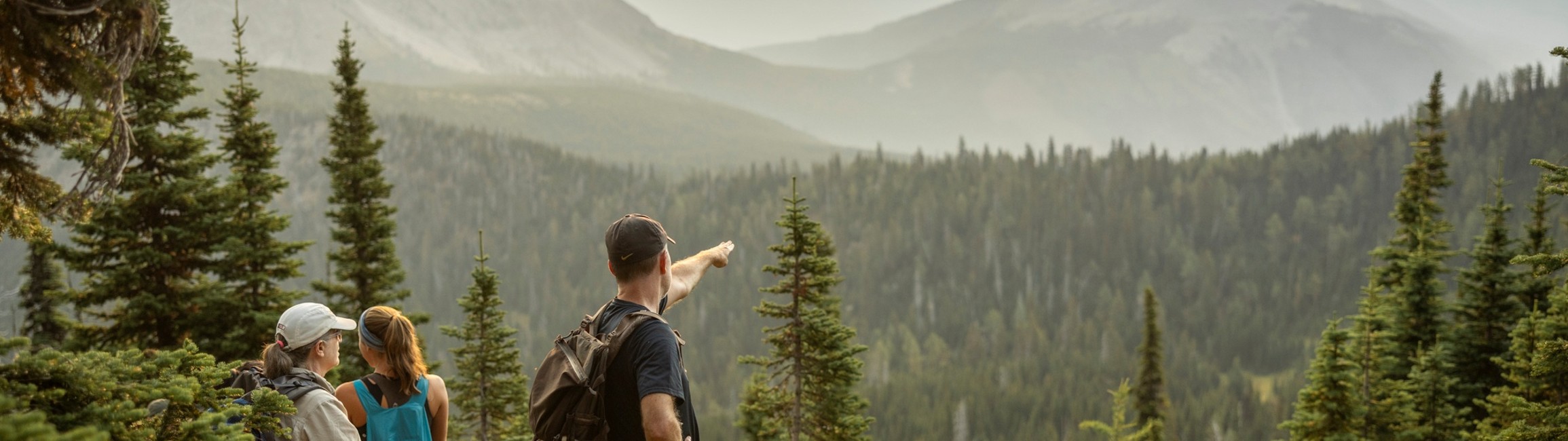 a hiker points off into the distance