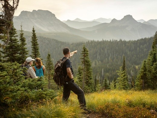 a hiker points off into the distance